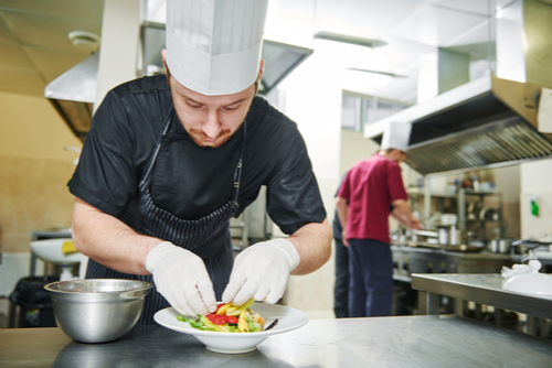 Chef Using White Gloves to Garnish a Dish